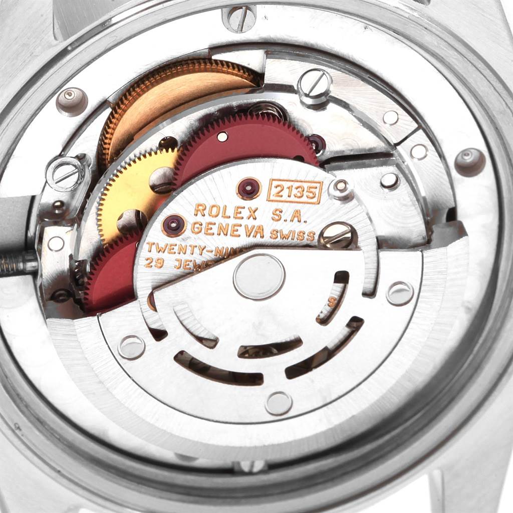 This image provides an overhead view of the internal mechanics of a Mid-Size Rolex watch, showcasing the movement and gears.