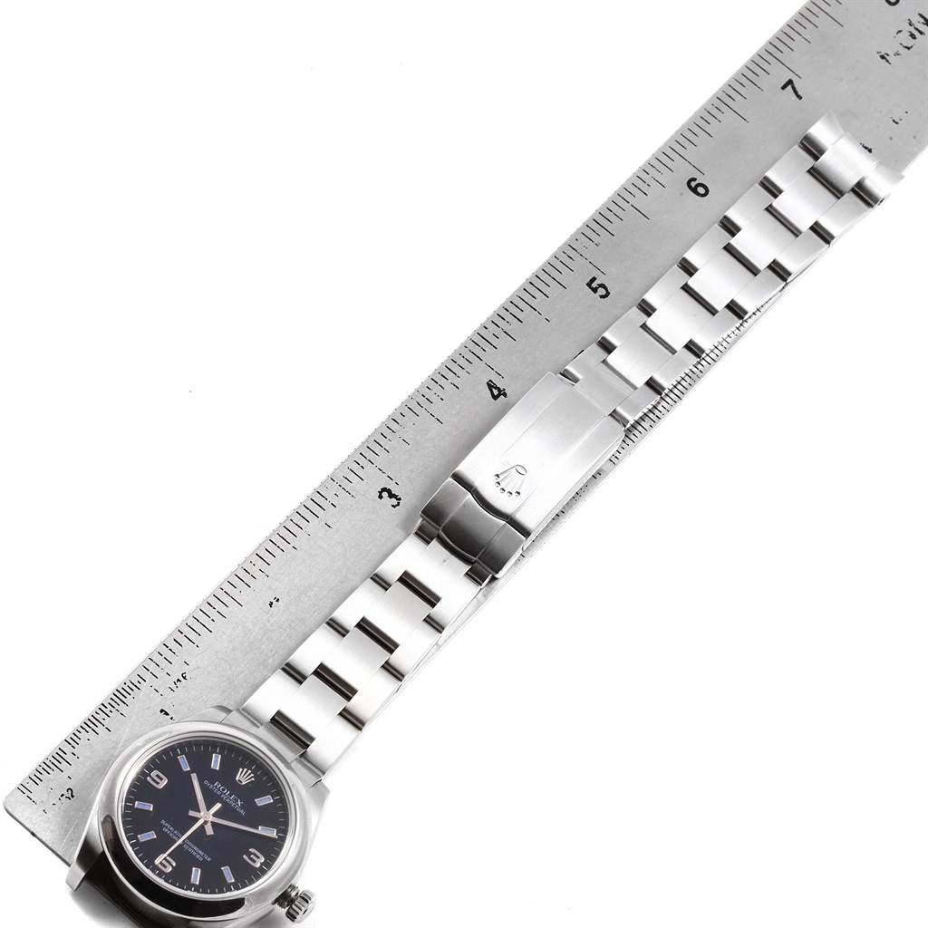 The image shows a Rolex Mid-Size 177200 Women's Stainless Steel Black Dial 177200 Women's Stainless Steel Black Dial watch face and bracelet laid flat along a ruler for measurement.