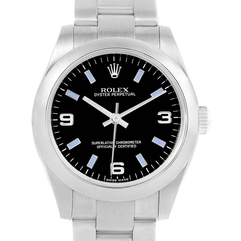 The image shows a front view of a Rolex Oyster Perpetual Mid-Size watch, highlighting its black dial, hour markers, and metal bracelet.
