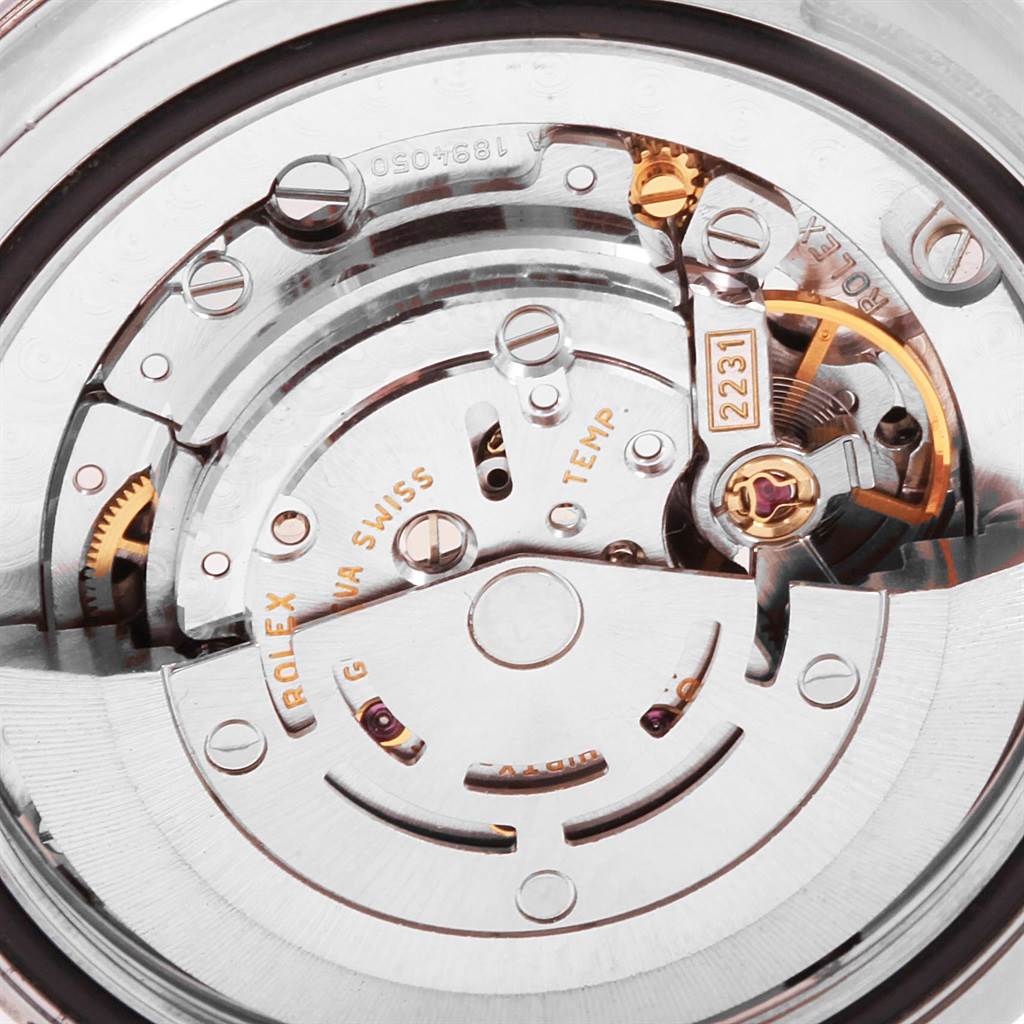 The image shows the internal mechanism of a Mid-Size Rolex watch viewed from the back.
