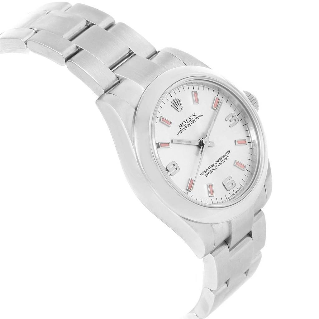 The image shows a Mid-Size Rolex Oyster Perpetual watch from a three-quarter angle, displaying its silver bracelet, case, and white dial.