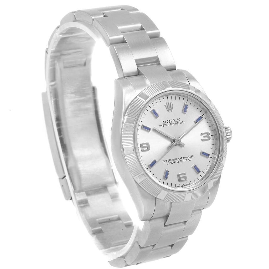 The Rolex Oyster Perpetual Mid-Size watch is shown at a three-quarter angle, displaying the face, bezel, and bracelet.