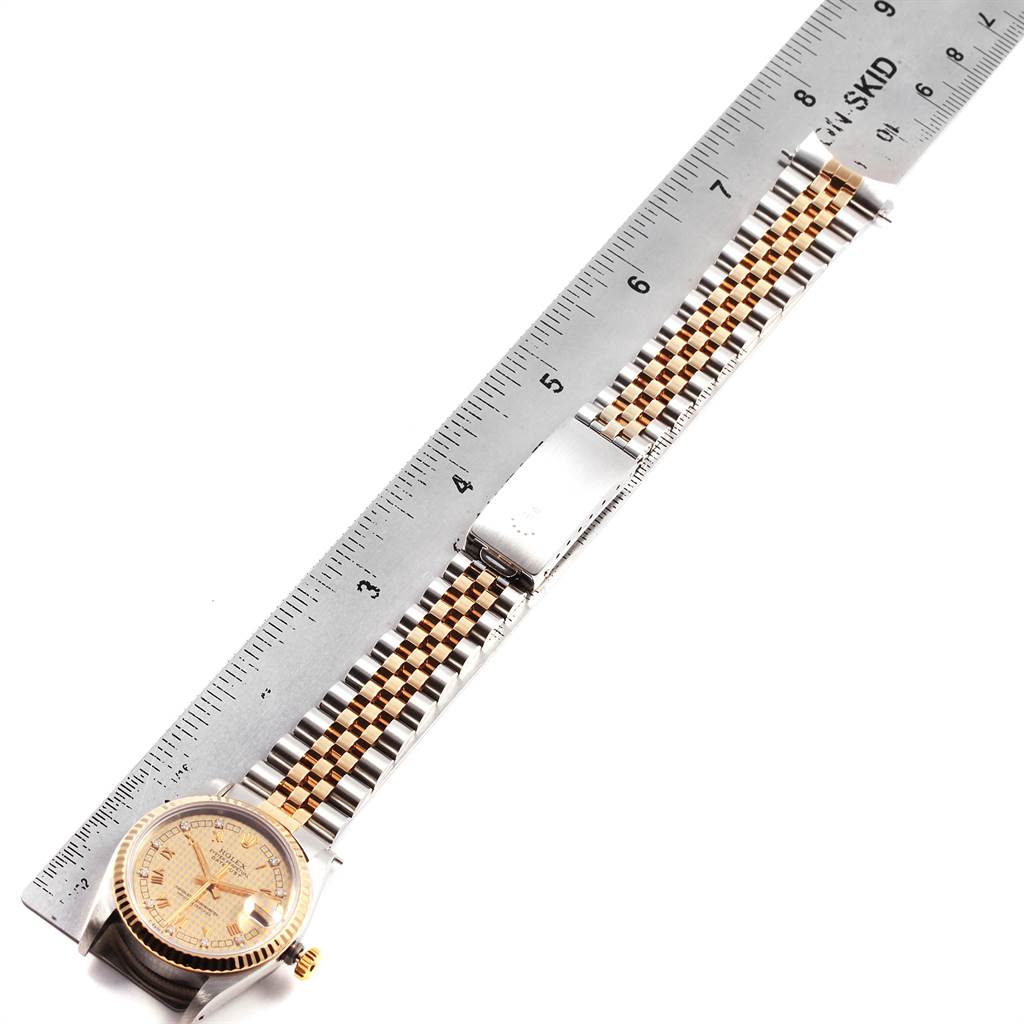 The image shows a Rolex Mid-Size 68273 Women's Steel and Gold (two tone) Champagne Dial 68273 Women's Steel and Gold (two tone) Champagne Dial watch placed alongside a ruler, displaying its bracelet, clasp, and watch face from a top-down angle.