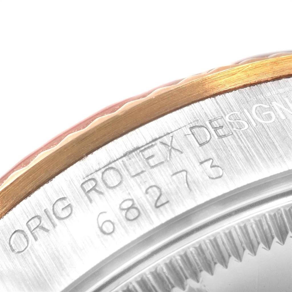 Close-up of the bezel and engraving on a Mid-Size Rolex watch showing the "ORIG ROLEX DESIGN" inscription and model number.