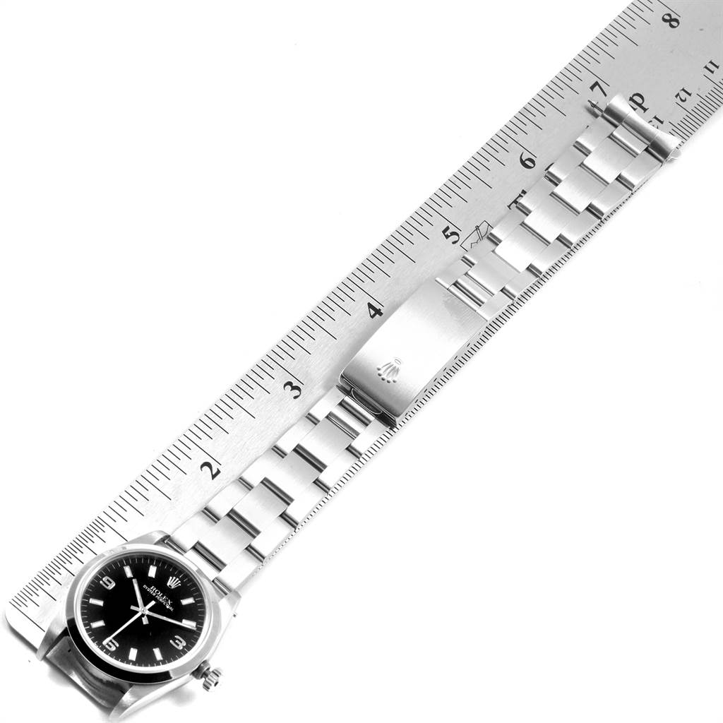 The image shows a Rolex Mid-Size 67480 Women's Stainless Steel Black Dial 67480 Women's Stainless Steel Black Dial model watch from an overhead angle, featuring its face, bracelet, and clasp.