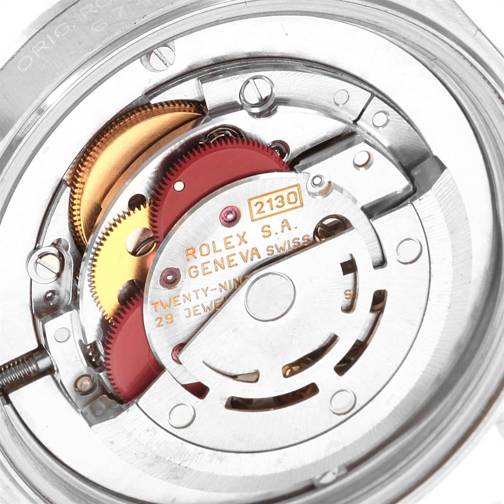 The image shows an internal view of the Rolex Mid-Size 67480 Women's Stainless Steel Black Dial 67480 Women's Stainless Steel Black Dial model watch's movement, specifically the 2130 caliber mechanism.