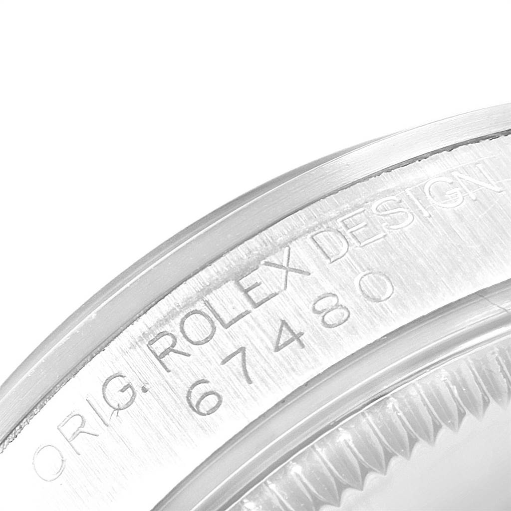 The image shows a close-up of the case back and serial number of the Mid-Size Rolex watch, model number 67480.