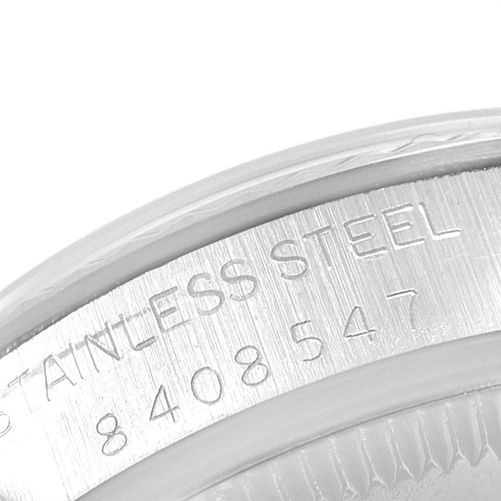 The image shows a close-up of a stainless steel part with serial numbers from a Rolex Mid-Size 67514 Women's Stainless Steel Silver Dial 67514 Women's Stainless Steel Silver Dial model watch.