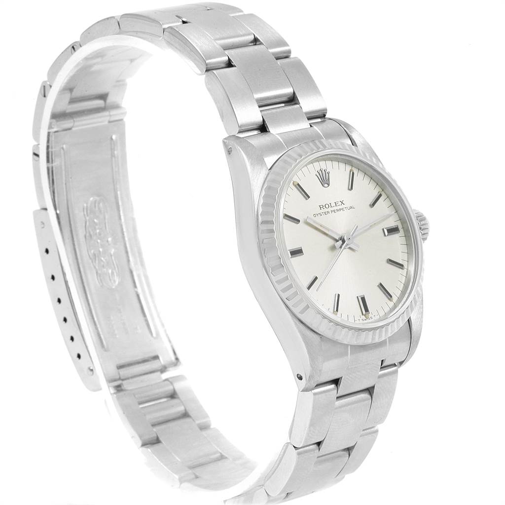This image shows a side angle of a Rolex Mid-Size 67514 Women's Stainless Steel Silver Dial 67514 Women's Stainless Steel Silver Dial Oyster Perpetual watch, highlighting its bracelet, case, and dial.