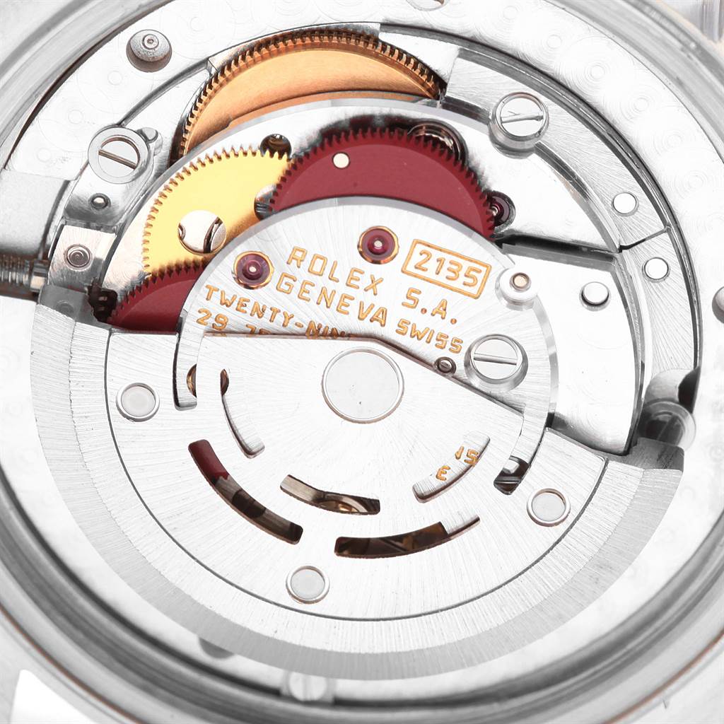 This image shows a close-up of the movement mechanism inside a Rolex Mid-Size 68273 Women's Steel and Gold (two tone) Champagne Dial 68273 Women's Steel and Gold (two tone) Champagne Dial watch, model 2135.