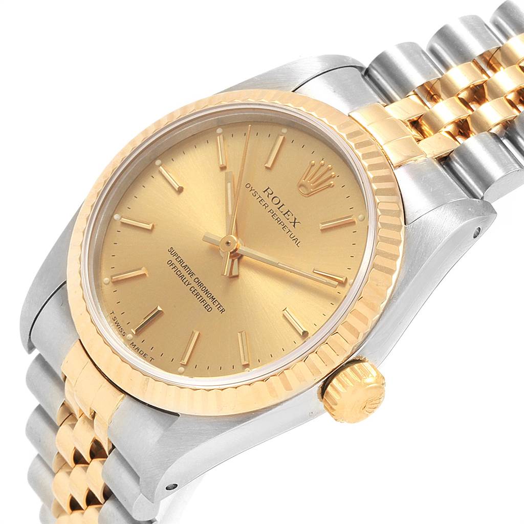 The image shows a Rolex Oyster Perpetual Mid-Size watch from an angled side view, highlighting the dial, crown, and partially the bracelet.