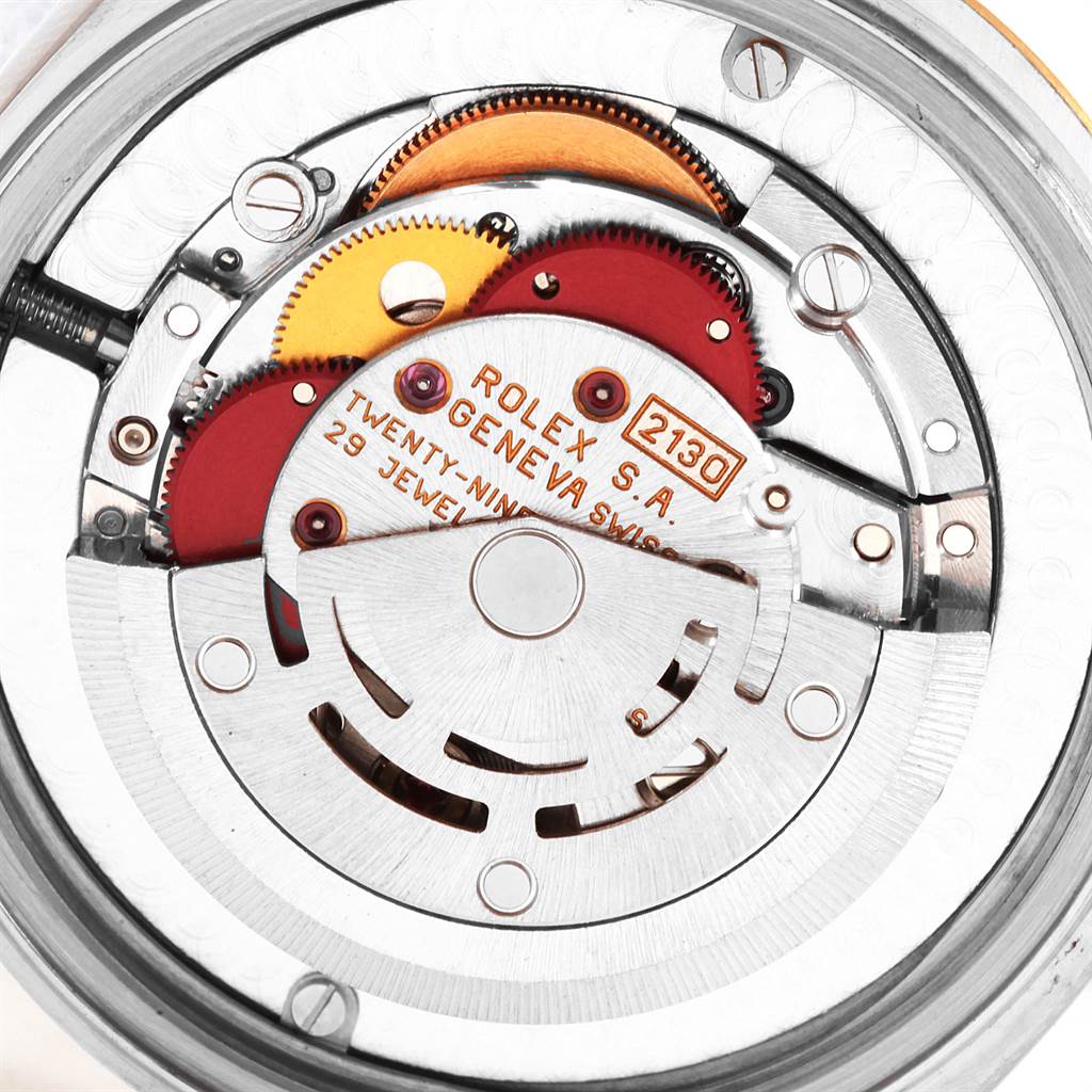 Close-up view of the movement and intricate inner mechanisms of a Rolex Mid-Size 67513 Women's Steel and Gold (two tone) Champagne Dial 67513 Women's Steel and Gold (two tone) Champagne Dial watch.