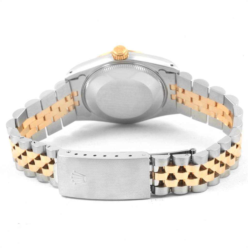 The image displays the back of the casing and the two-tone bracelet of a Mid-Size Rolex watch, focusing on the clasp and bracelet links.