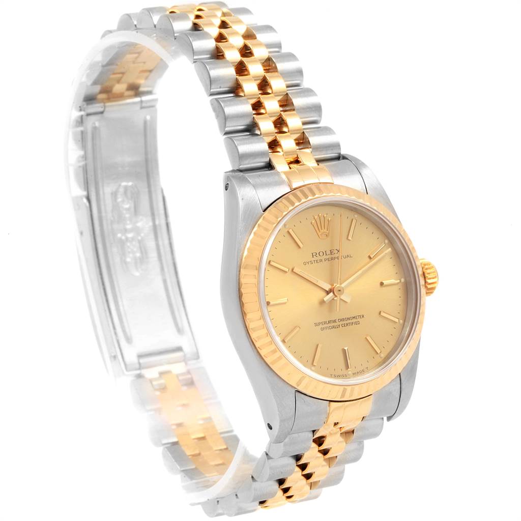 The image shows a side angle of a Rolex Oyster Perpetual Mid-Size watch, highlighting its two-tone bracelet and gold dial.