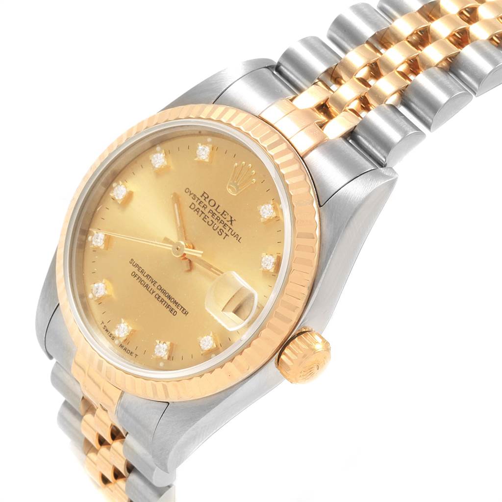 The image shows a gold and silver Rolex Mid-Size 68273 Women's Steel and Gold (two tone) Champagne Dial 68273 Women's Steel and Gold (two tone) Champagne Dial Oyster Perpetual Datejust watch at an angled close-up view, highlighting its face, bezel, and bracelet.