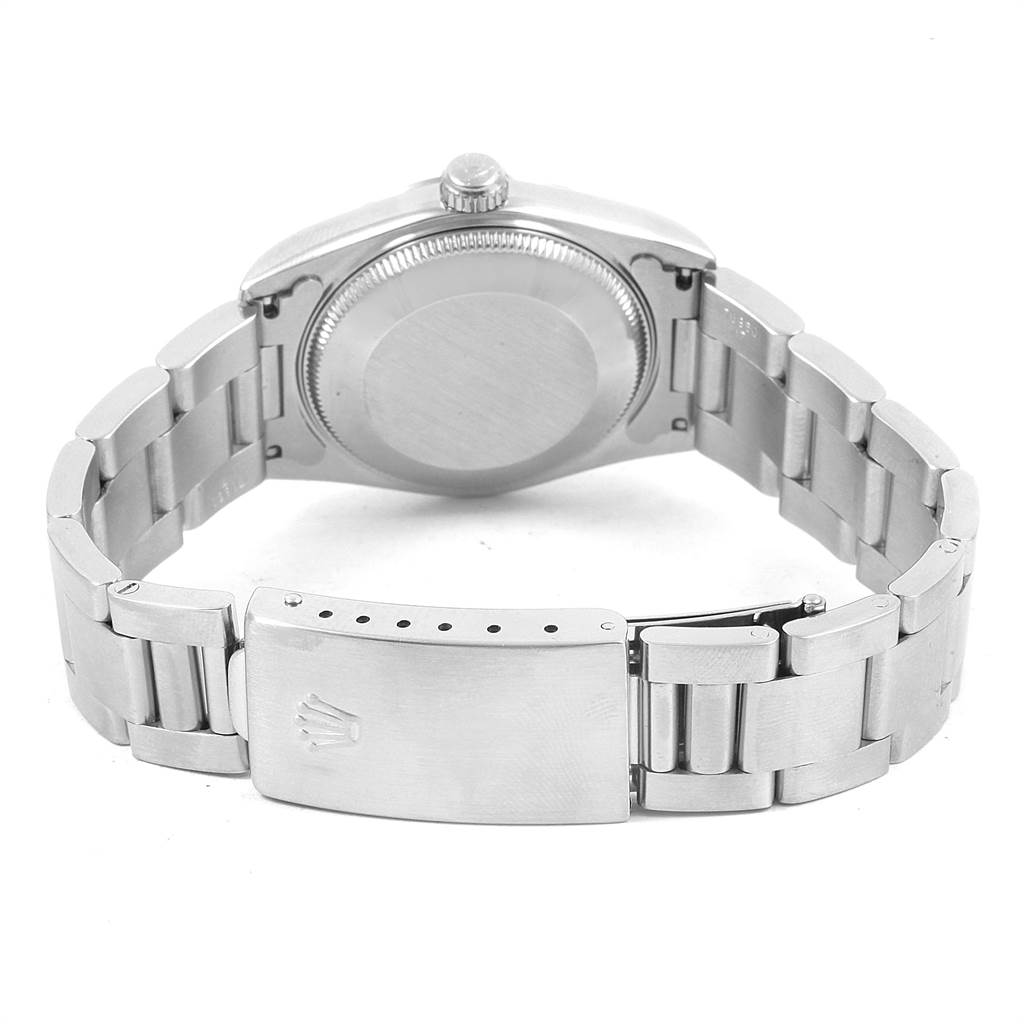 This image shows the back view of a Mid-Size Rolex watch, focusing on the caseback and the bracelet clasp.