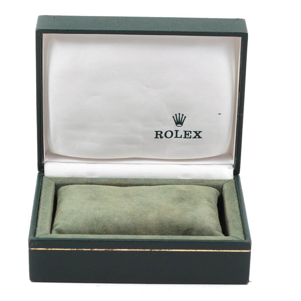 The image shows an open Rolex watch box with a cushion inside, angled from the front.