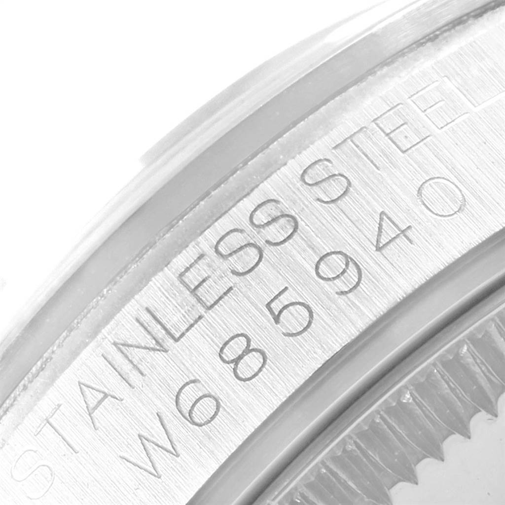 This close-up image of a Rolex Mid-Size 67480 Women's Stainless Steel White Dial 67480 Women's Stainless Steel White Dial watch shows part of the case with "STAINLESS STEEL W685940" engraved.