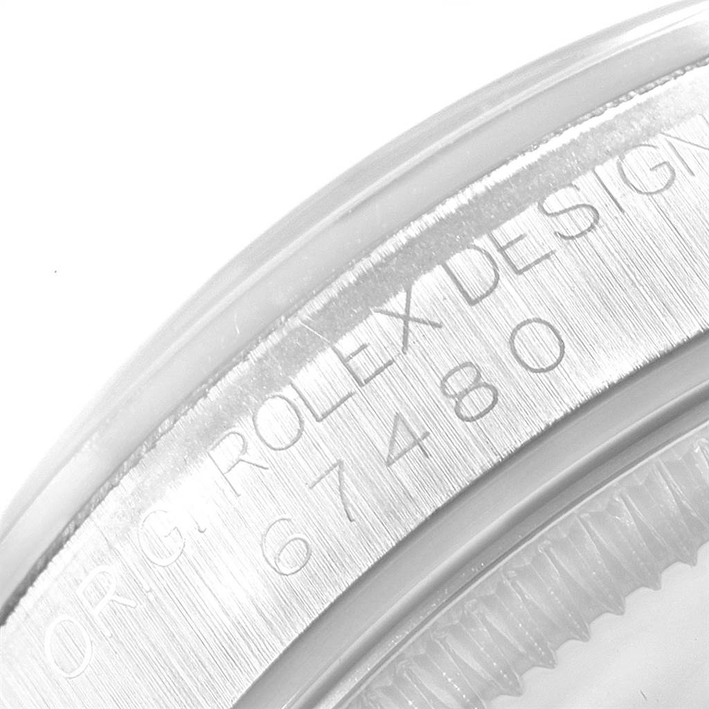 This image shows a close-up of the case edge and engraved serial number of a Mid-Size Rolex watch model 67480.