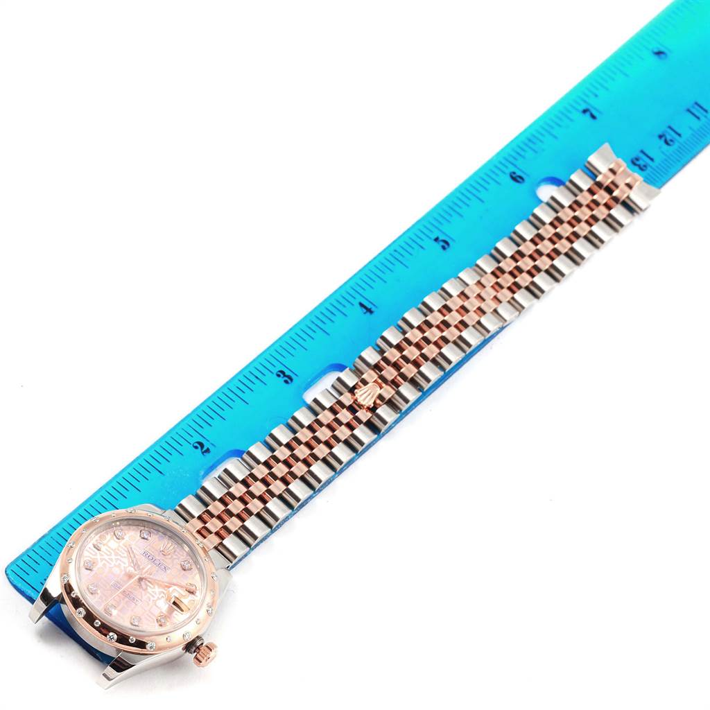 The image shows the top view of a Rolex Mid-Size 178341 Women's Steel and Gold (two tone) Pink Dial 178341 Women's Steel and Gold (two tone) Pink Dial watch, including the face and full bracelet, alongside a ruler for scale.