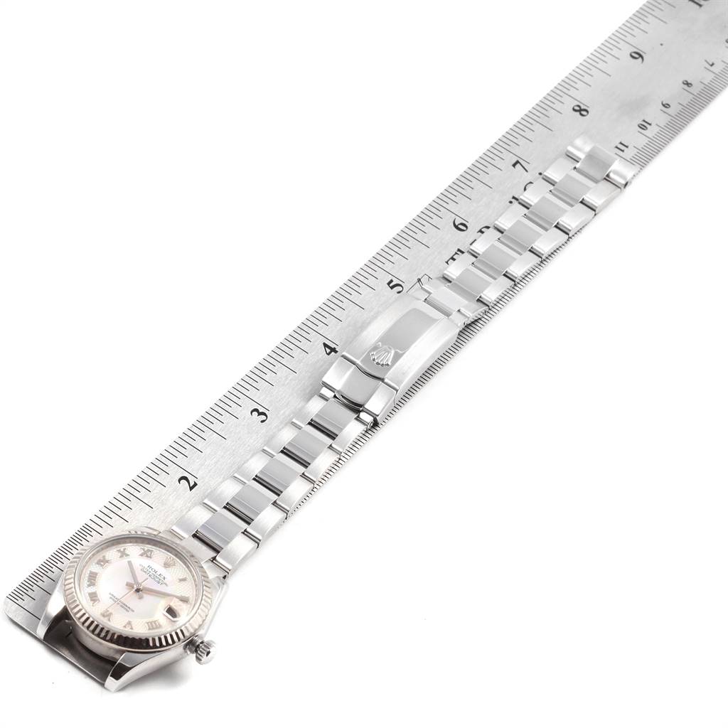 The image shows the full length of a Rolex Mid-Size 178274 Women's Stainless Steel Mother of Pearl Dial 178274 Women's Stainless Steel Mother of Pearl Dial model watch, with its bracelet and clasp laid out parallel to a ruler.