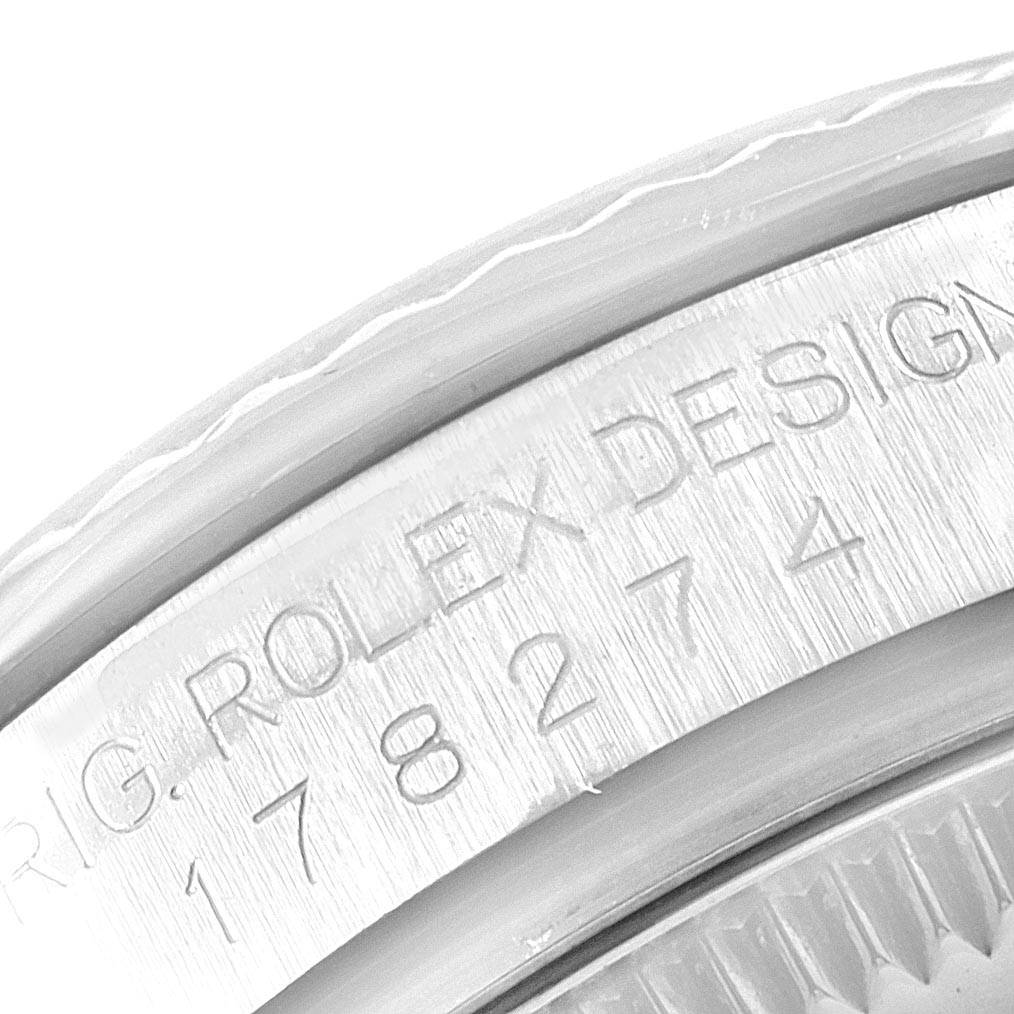 The image shows an angled close-up of the case back of a Mid-Size Rolex watch with "ROLEX DESIGN" and a serial number engraved.