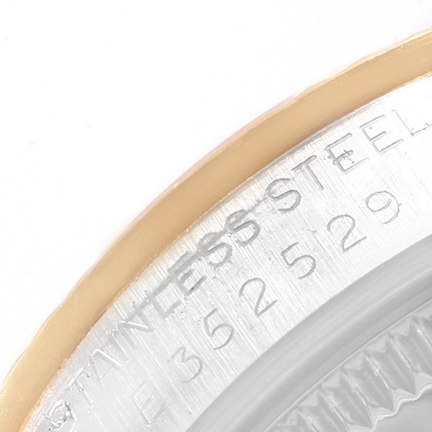 This image shows a close-up angle of the case and bezel of the Rolex Mid-Size 68273 Women's Steel and Gold (two tone) White Dial 68273 Women's Steel and Gold (two tone) White Dial model watch, highlighting the serial number and "Stainless Steel" inscription.