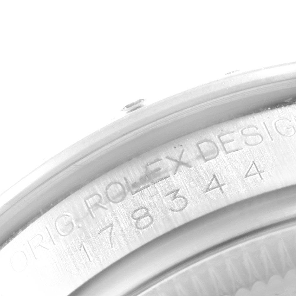 This close-up image of a Rolex Mid-Size 178344 Women
s Stainless Steel Brown Dial 178344 Women
s Stainless Steel Brown Dial model shows part of the watch case with engraved text and serial numbers.