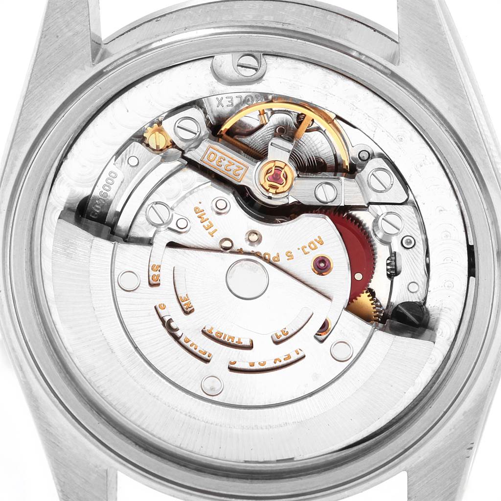 The image shows the back view of the inner mechanics and movement of a Mid-Size Rolex watch.
