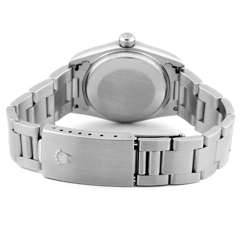 The image shows the back case and bracelet clasp of a mid-size Rolex watch, viewed from the rear.
