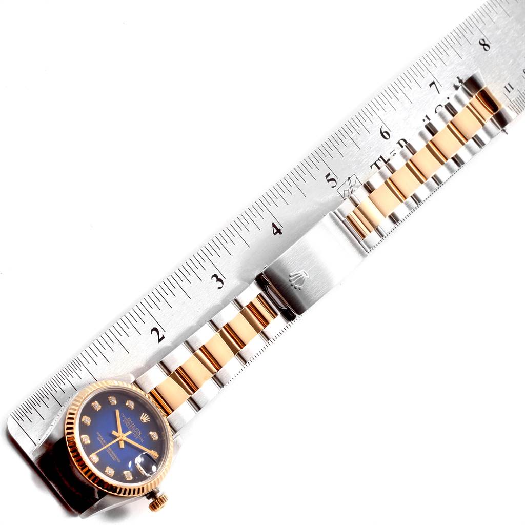 The image shows the bracelet and face of a Rolex Mid-Size 68273 Women's Steel and Gold (two tone) Blue Dial 68273 Women's Steel and Gold (two tone) Blue Dial model watch, measured against a ruler.