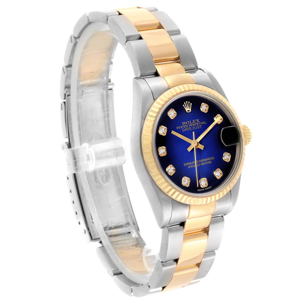 This image shows a side angle view of a Rolex Mid-Size 68273 Women's Steel and Gold (two tone) Blue Dial 68273 Women's Steel and Gold (two tone) Blue Dial Oyster Perpetual Datejust watch, featuring its bracelet, bezel, and dial.