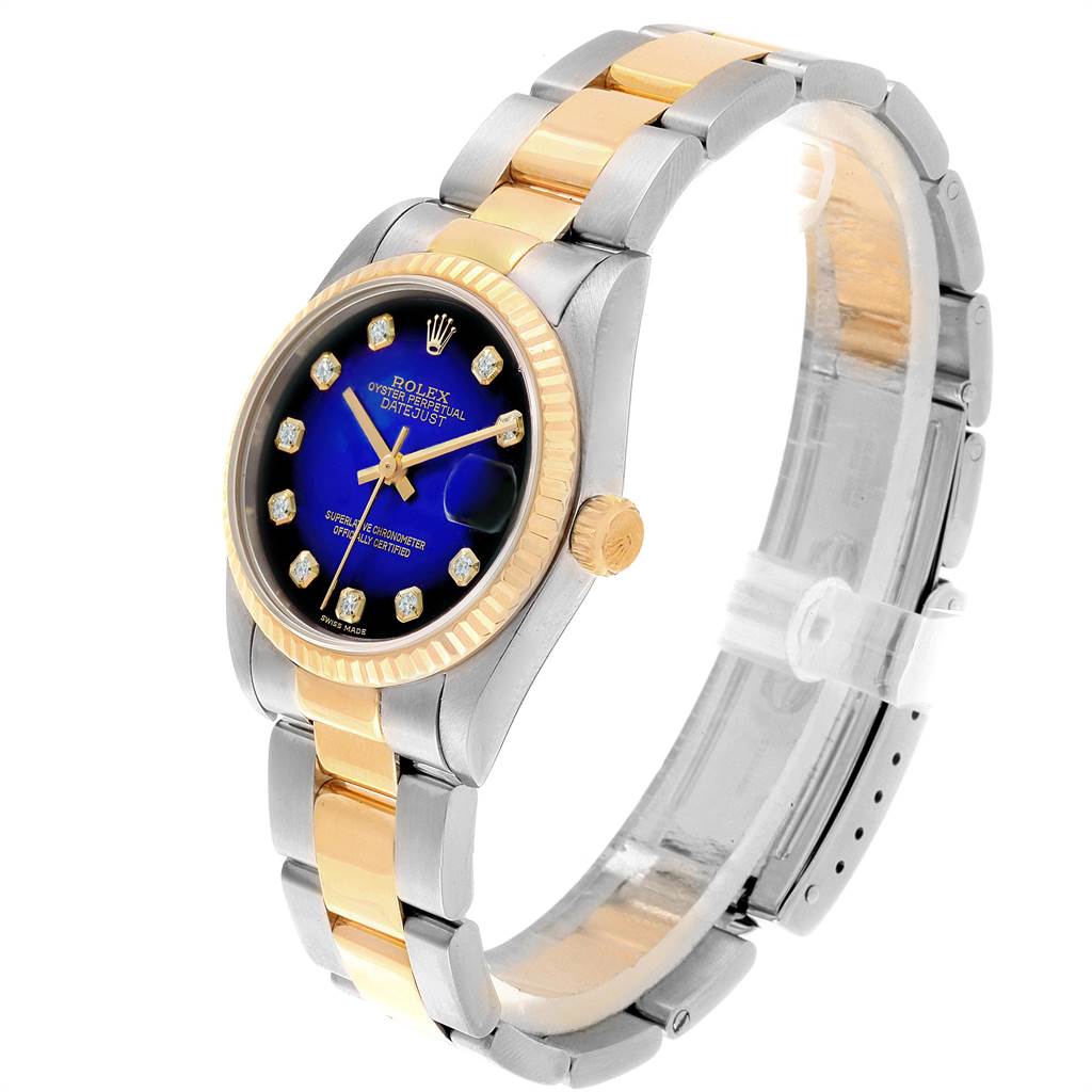 The Rolex Mid-Size 68273 Women's Steel and Gold (two tone) Blue Dial 68273 Women's Steel and Gold (two tone) Blue Dial model watch is shown at an angle, highlighting its blue dial, two-tone bracelet, and fluted bezel.