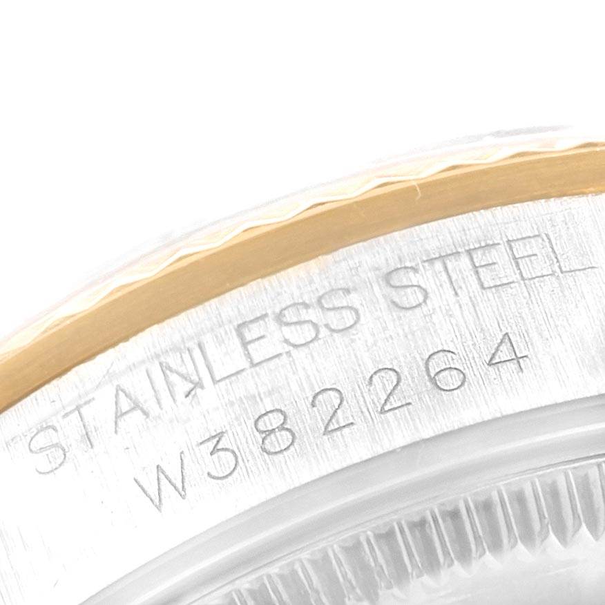 This is a close-up of the case back edge of a Mid-Size Rolex watch, showing the serial number and "STAINLESS STEEL" engraving.