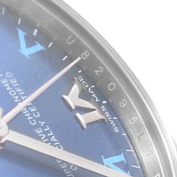 The image shows a close-up of the dial and hands of a Mid-Size Rolex watch, viewed from an angle highlighting the bezel and hour markers.