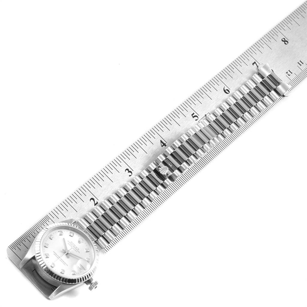 The image shows a side angle of a Rolex Mid-Size 68279 Women's White Gold Silver Dial 68279 Women's White Gold Silver Dial watch, highlighting the bracelet and part of the dial, alongside a ruler.