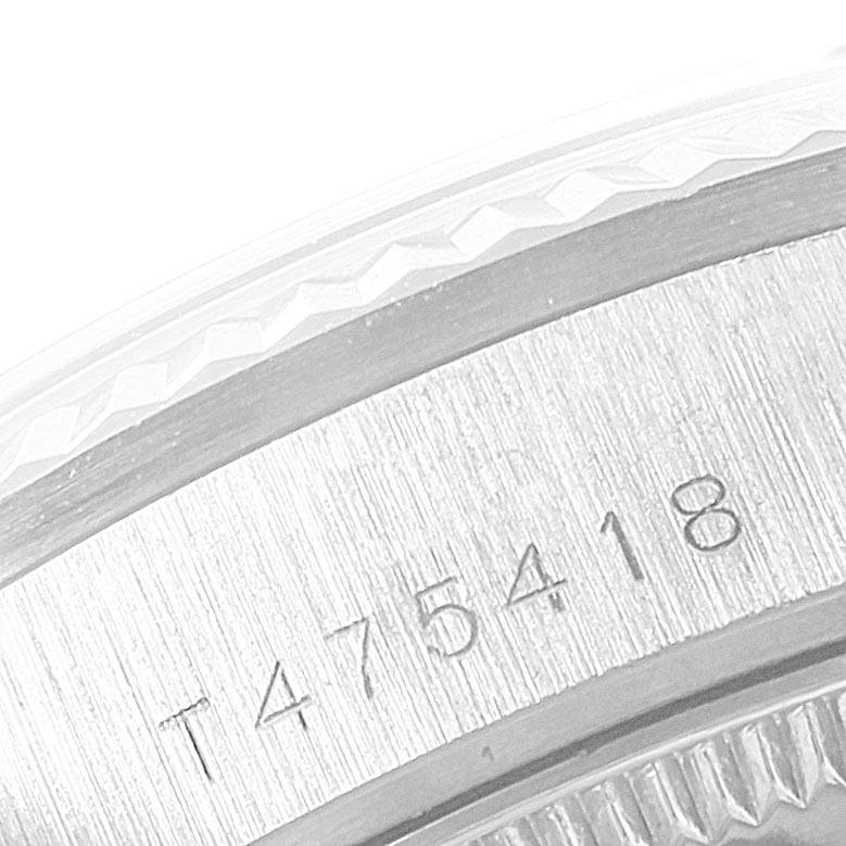 The image shows a close-up of the side and engraved serial number of the Rolex Mid-Size 68279 Women's White Gold Silver Dial 68279 Women's White Gold Silver Dial model watch bezel.