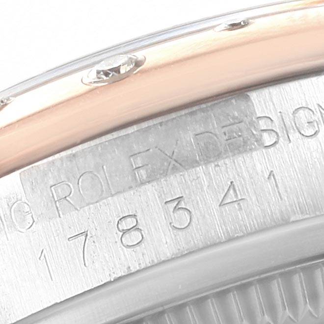 The image shows a close-up of the case side and serial number area on a Mid-Size Rolex watch.