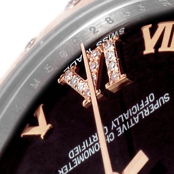 This image shows a close-up of the dial, hour markers, and hands of a Mid-Size Rolex watch.