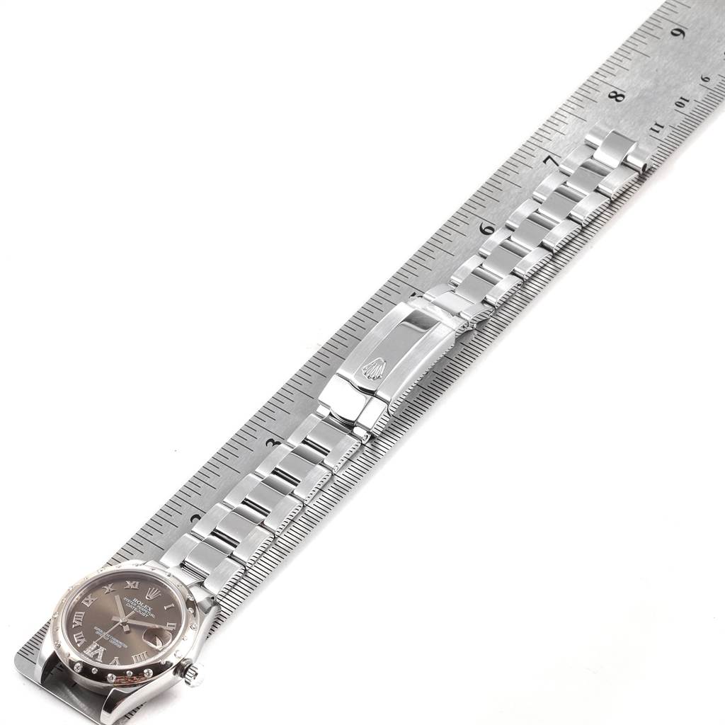 The image shows a steel Rolex Mid-Size 178344 Women's Stainless Steel Brown Dial 178344 Women's Stainless Steel Brown Dial watch laid flat with its bracelet extended, next to a ruler for measurement.