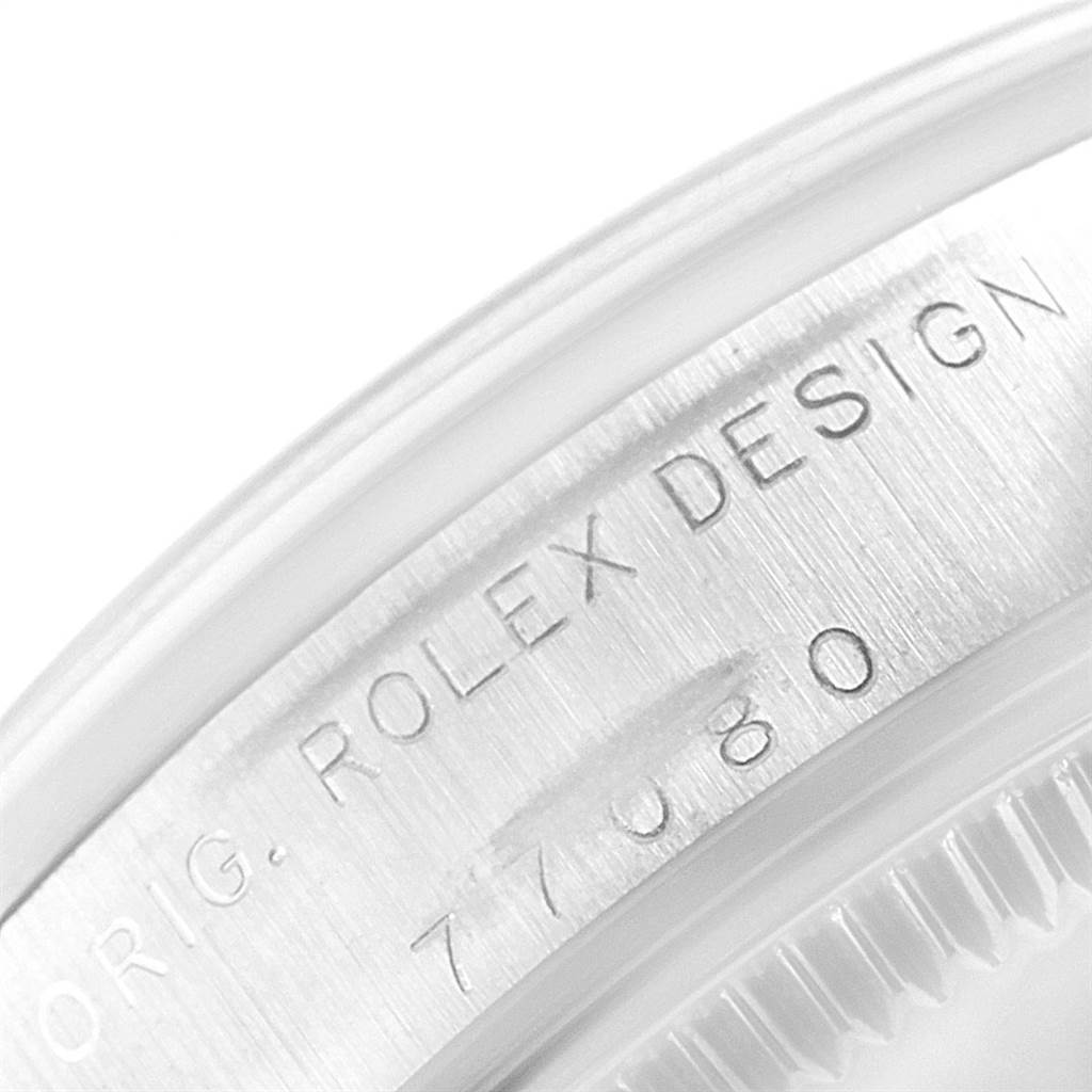 This image shows a close-up of the engraved model number "77080" and "ROLEX DESIGN" on the case of a Rolex Mid-Size 77080 Women's Stainless Steel Silver Dial 77080 Women's Stainless Steel Silver Dial watch.