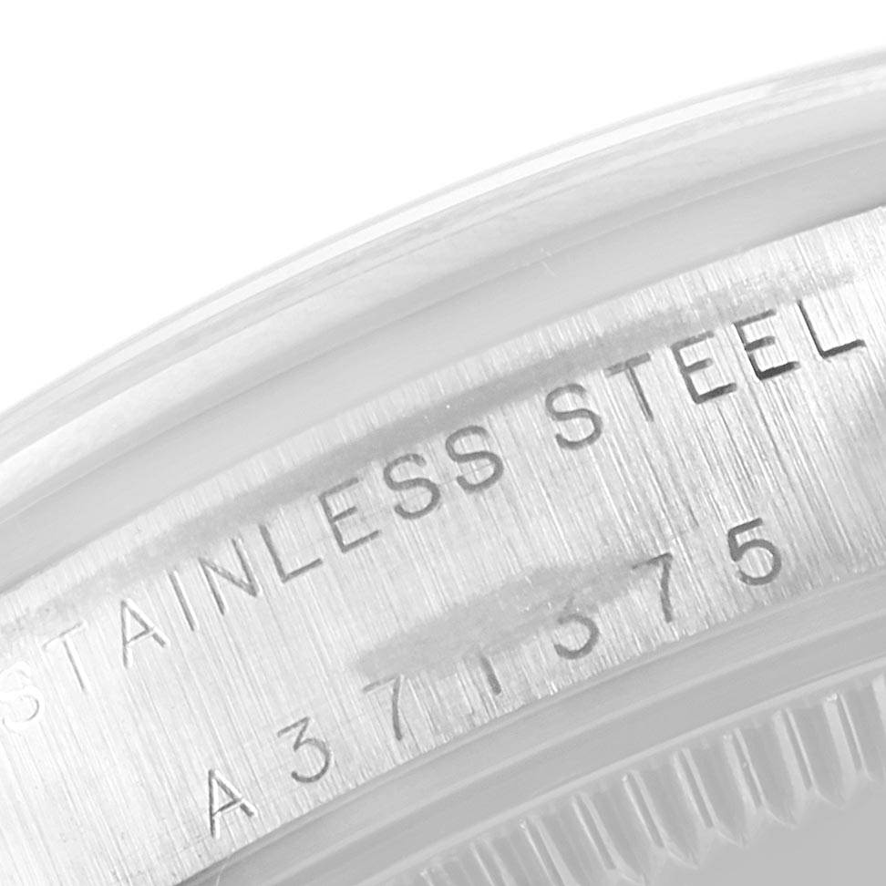 This image shows a close-up of the serial number and material engraving on a stainless steel Rolex Mid-Size 77080 Women's Stainless Steel Silver Dial 77080 Women's Stainless Steel Silver Dial model watch.