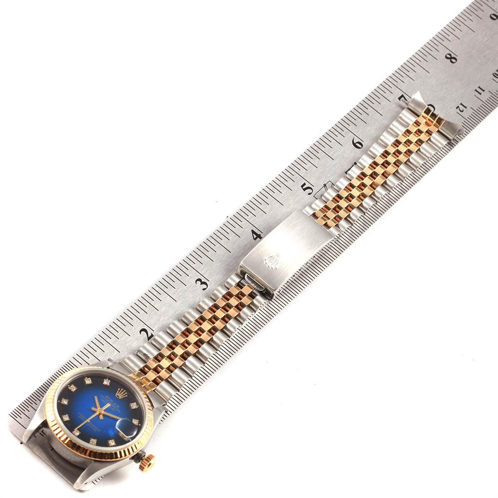 The image shows a Mid-Size Rolex watch with a blue dial and bi-metal bracelet, measured against a ruler.