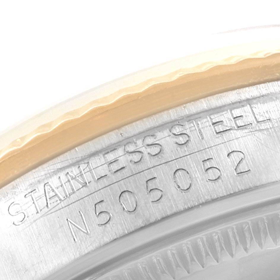 This close-up image shows the stainless steel casing and serial number of a Mid-Size Rolex watch.