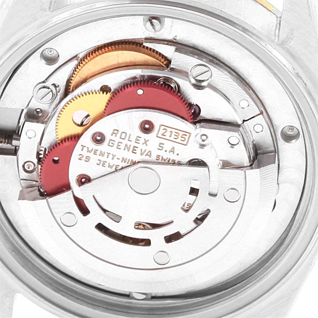 The image shows the inner movement mechanism of a Mid-Size Rolex watch, viewed from the case back.