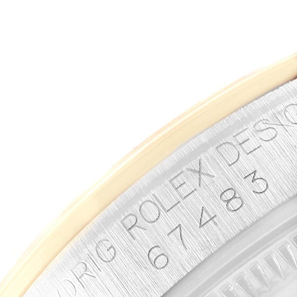 This close-up angle of the Rolex Mid-Size 67483 Women's Steel and Gold (two tone) Grey Dial 67483 Women's Steel and Gold (two tone) Grey Dial model shows the engraved serial number on its casing.
