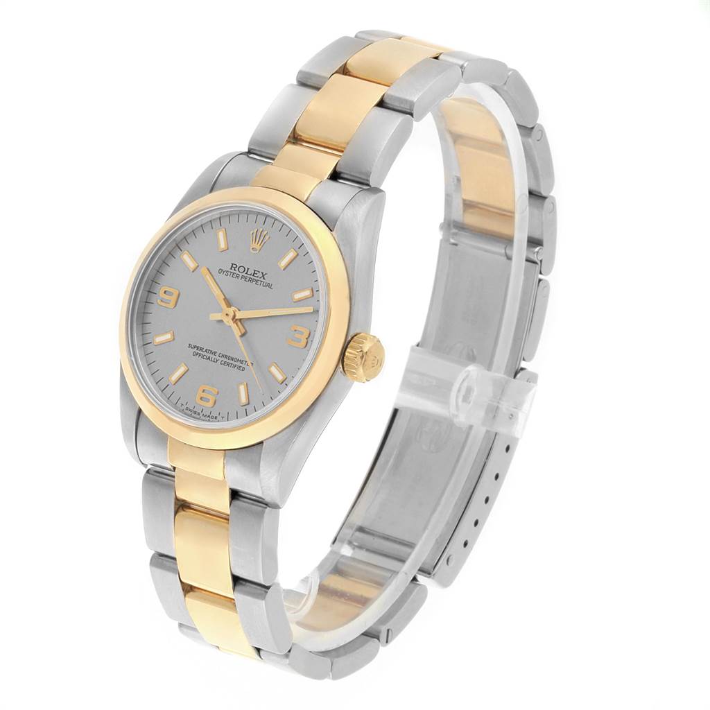 The Rolex Mid-Size 67483 Women's Steel and Gold (two tone) Grey Dial 67483 Women's Steel and Gold (two tone) Grey Dial watch is shown at a three-quarter angle, featuring its two-tone bracelet, silver dial, and gold accents.