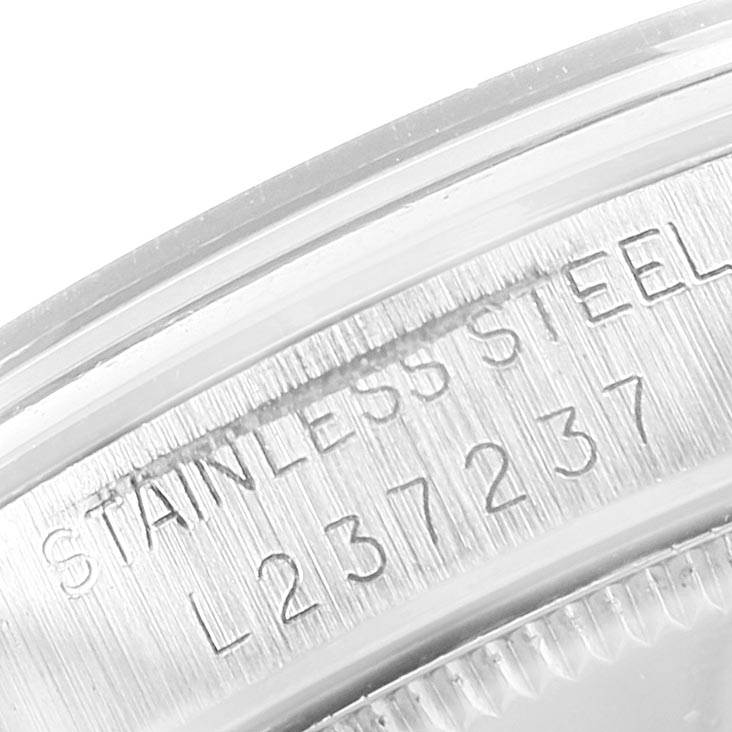 This image shows a close-up of the stainless steel casing with the serial number of a Mid-Size Rolex watch.