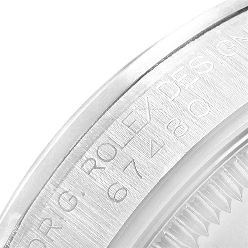 This image shows a close-up view of the engraved bezel of a Mid-Size Rolex watch.