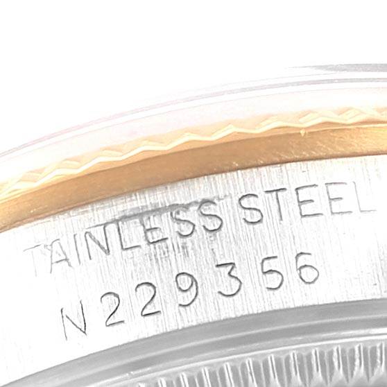 The image shows a close-up of the side of a Rolex Mid-Size 68273 Women's Steel and Gold (two tone) Champagne Dial 68273 Women's Steel and Gold (two tone) Champagne Dial watch, displaying the stainless steel casing and serial number.